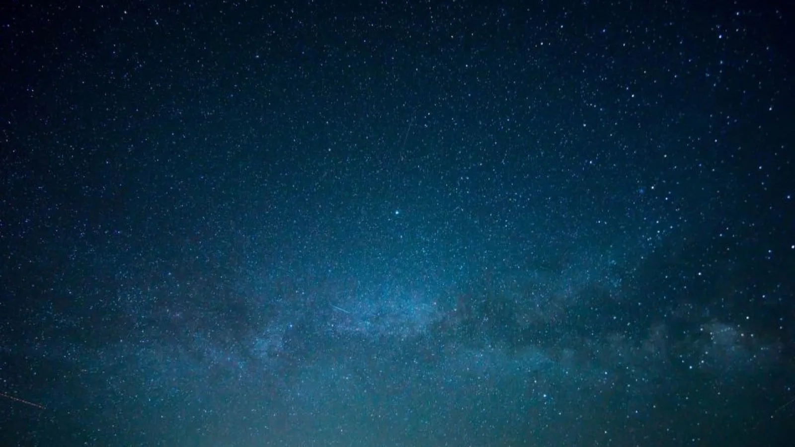 A dark starlit night sky